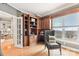A home office featuring custom built-in shelving, a cushioned chair, and a large bright window at 572 N Church St, Charlotte, NC 28202