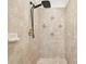 Close-up of a shower with neutral tile and stylish shower head at 572 N Church St, Charlotte, NC 28202