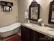 Elegant bathroom featuring a clawfoot tub and a dark wood vanity with granite countertop at 591 Bent Oak Trl, Concord, NC 28027