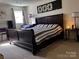 Bedroom with dark wood sleigh bed, side table, and window at 591 Bent Oak Trl, Concord, NC 28027