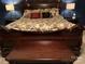 Ornate bedroom features a dark wood sleigh bed with decorative pillows and bedside lamps at 591 Bent Oak Trl, Concord, NC 28027