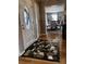 Inviting foyer with decorative tile inlay, hardwood floors, and a view into the dining room at 591 Bent Oak Trl, Concord, NC 28027