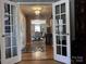 Inviting foyer with decorative tile inlay, hardwood floors, and a view into the dining room at 591 Bent Oak Trl, Concord, NC 28027