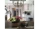 Bright, white kitchen with stainless steel appliances, ample counter space and a stylish chandelier at 591 Bent Oak Trl, Concord, NC 28027
