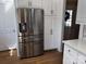 Bright kitchen with stainless steel refrigerator, hardwood floors, and white cabinets at 591 Bent Oak Trl, Concord, NC 28027
