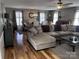 Open-concept living room with hardwood floors, comfortable seating, and dining area beyond at 591 Bent Oak Trl, Concord, NC 28027