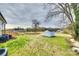 The backyard has a shed, grassy lawn, a wooden deck, and trees around the perimeter at 611 N York St, Gastonia, NC 28052