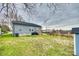 Wide shot of the backyard featuring a wooden deck, grassy lawn, and view of the neighborhood at 611 N York St, Gastonia, NC 28052