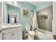 Bathroom featuring modern vanity, stylish fixtures, tiled shower with niche, toilet, and framed mirror at 611 N York St, Gastonia, NC 28052