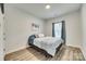 Cozy bedroom features window, neutral walls, and laminate wood-look flooring at 611 N York St, Gastonia, NC 28052