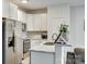 Modern kitchen featuring white cabinets, stainless steel appliances, and marble countertops at 611 N York St, Gastonia, NC 28052