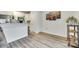 Bright open-concept living and kitchen area with modern flooring, neutral walls, and decorative artwork at 611 N York St, Gastonia, NC 28052