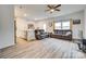 Open living room featuring hardwood floors, neutral colors, and a ceiling fan at 611 N York St, Gastonia, NC 28052