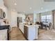 Modern kitchen with a large island, stainless steel appliances, and an open layout to the dining area at 6271 Fairfax Ct, Maiden, NC 28650