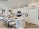 Bright kitchen featuring an island with seating, white cabinets, stainless steel appliances, and hardwood floors at 6271 Fairfax Ct, Maiden, NC 28650