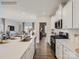 Open-concept kitchen featuring a large island, white cabinets, stainless steel appliances, and hardwood floors at 6271 Fairfax Ct, Maiden, NC 28650