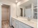 Bathroom featuring double sinks, quartz countertops, large mirror, and a walk-in closet at 6277 Fairfax Ct, Maiden, NC 28650