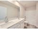 Bathroom featuring double sinks, quartz countertops, a bathtub with shower, and tile flooring at 6277 Fairfax Ct, Maiden, NC 28650