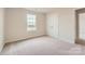 Well-lit bedroom with neutral walls, carpet flooring, double closet, and a large window at 6277 Fairfax Ct, Maiden, NC 28650