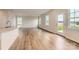Open-concept living space with wood floors, a kitchen island, and a door leading to the backyard at 6277 Fairfax Ct, Maiden, NC 28650