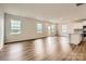 Bright and spacious living room featuring wood floors, recessed lighting, and multiple windows for ample natural light at 6277 Fairfax Ct, Maiden, NC 28650