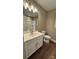 Bright bathroom featuring a single vanity with a white countertop, and a toilet at 8703 Ellington Park Dr, Charlotte, NC 28277