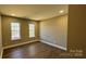 Cozy bedroom with hardwood floors, two windows, and neutral paint, creating a peaceful retreat at 8703 Ellington Park Dr, Charlotte, NC 28277