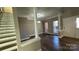 Inviting living room with columns, hardwood floors, large windows, and great natural light at 8703 Ellington Park Dr, Charlotte, NC 28277