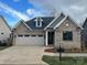 Charming one-story brick home with a two-car garage and well-manicured lawn at #92 Silver Trace Ln, Denver, NC 28037