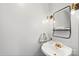 Stylish powder room featuring a pedestal sink, sleek mirror, and modern lighting fixtures at 1420 11Th Street Nw Dr # 15, Hickory, NC 28601