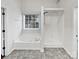 Bathroom featuring a soaking tub, a glass-enclosed shower, and neutral tones for a clean, modern look at 11124 Chastain Parc Dr, Charlotte, NC 28216