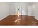 Spacious bedroom featuring hardwood floors, and double doors into a hallway at 11124 Chastain Parc Dr, Charlotte, NC 28216