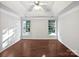 Bright bedroom with two windows, a tray ceiling, and hardwood floors awaiting personalized touches at 11124 Chastain Parc Dr, Charlotte, NC 28216