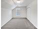 Bright bedroom featuring gray carpet, a window, and a closet at 11124 Chastain Parc Dr, Charlotte, NC 28216