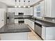 Well-equipped kitchen featuring stainless steel appliances, granite countertops, and white cabinetry at 11124 Chastain Parc Dr, Charlotte, NC 28216