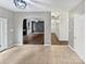 Open concept view of the tiled dining area and the living room with a fireplace and hardwood floors at 11124 Chastain Parc Dr, Charlotte, NC 28216