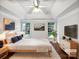 Tranquil bedroom with a tray ceiling, two windows, and warm hardwood floors with modern furnishings at 11124 Chastain Parc Dr, Charlotte, NC 28216