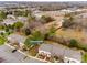 Aerial view of the homes featuring nearby roads, parking, and a mix of deciduous and evergreen trees at 11426 Savannah Creek Dr, Charlotte, NC 28273