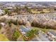 Aerial view of the community featuring a mix of residential homes, nearby businesses, and mature trees at 11426 Savannah Creek Dr, Charlotte, NC 28273