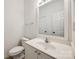 Bright half bathroom features a white vanity, matching toilet, and a neutral color palette at 11426 Savannah Creek Dr, Charlotte, NC 28273