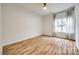 This bedroom offers wood floors, a ceiling fan, natural light, and ample space at 11426 Savannah Creek Dr, Charlotte, NC 28273