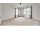 This bedroom features carpeted floors, two windows, and a ceiling fan at 11426 Savannah Creek Dr, Charlotte, NC 28273
