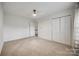 Bedroom featuring neutral carpet, a ceiling fan, and a closet with bi-fold doors at 11426 Savannah Creek Dr, Charlotte, NC 28273