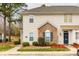 Inviting townhome exterior with brick accents, neat landscaping, and a welcoming entrance at 11426 Savannah Creek Dr, Charlotte, NC 28273