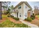 Well-maintained townhome exterior featuring vinyl siding, manicured bushes, and concrete walkway at 11426 Savannah Creek Dr, Charlotte, NC 28273