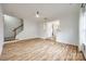 Open-concept living room with hardwood style floors, staircase, and natural light at 11426 Savannah Creek Dr, Charlotte, NC 28273