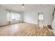 Spacious living room with beautiful wood floors, large windows, and neutral paint at 11426 Savannah Creek Dr, Charlotte, NC 28273