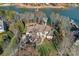 Aerial view of luxury waterfront home with private dock and meticulously maintained landscaping at 122 N Longfellow Ln, Mooresville, NC 28117