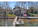 View of backyard leading to the lake; the dock is nicely framed and the lake is very inviting at 122 N Longfellow Ln, Mooresville, NC 28117