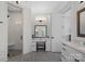 Bright bathroom features a vanity, a stool, tiled floors, a walk-in shower, and ample lighting at 122 N Longfellow Ln, Mooresville, NC 28117